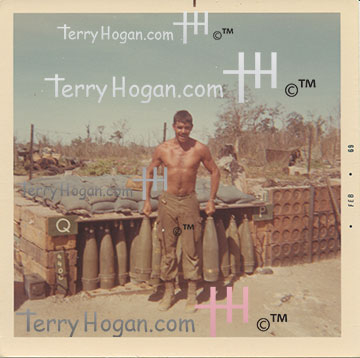 "TEX" "Tex" lifting two 98-pound artillery projectiles beside a 155mm howitzer in Vietnam.
